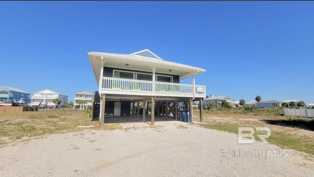 raised beach house featuring a carport