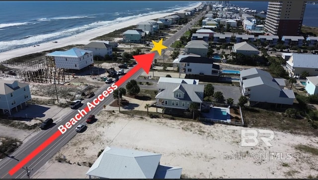 birds eye view of property featuring a water view and a view of the beach