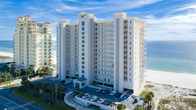 view of building exterior with a view of the beach and a water view