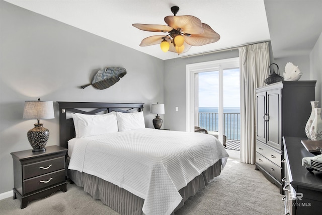 bedroom with light colored carpet, a water view, a ceiling fan, access to exterior, and baseboards