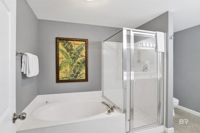 full bathroom with a stall shower, tile patterned flooring, and a bath