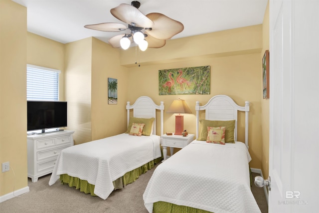 carpeted bedroom featuring a ceiling fan and baseboards