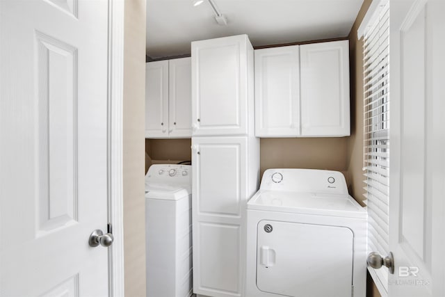 laundry area featuring cabinet space and separate washer and dryer