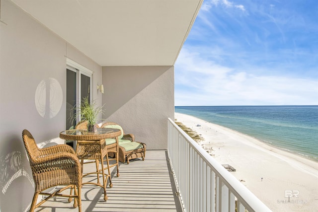 balcony with a water view and a beach view