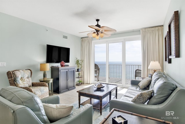 living area featuring a ceiling fan, visible vents, and light tile patterned flooring