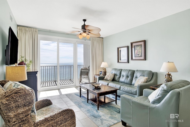 living area featuring ceiling fan, visible vents, and light tile patterned flooring