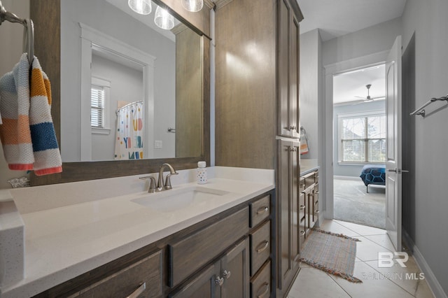 full bath featuring vanity, baseboards, and tile patterned floors