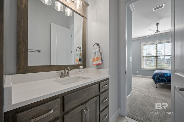 bathroom with visible vents, baseboards, ceiling fan, crown molding, and vanity