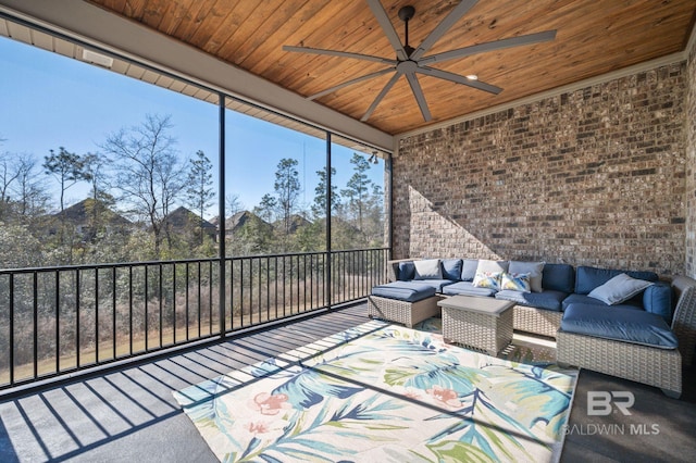 unfurnished sunroom featuring wood ceiling and a ceiling fan