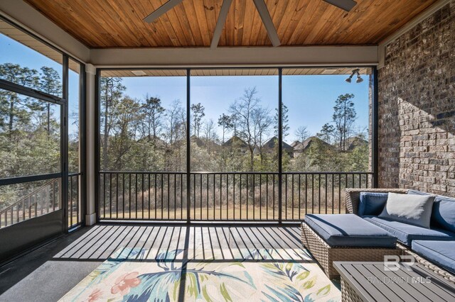 unfurnished sunroom featuring wooden ceiling and a ceiling fan