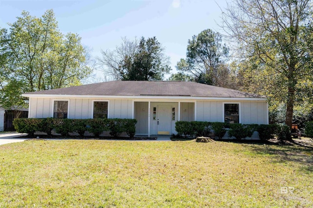 ranch-style house with board and batten siding, a porch, a front lawn, and fence