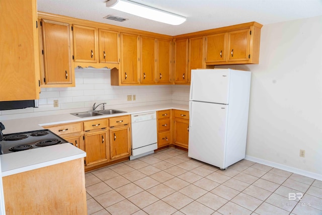 kitchen with light countertops, white appliances, a sink, and visible vents