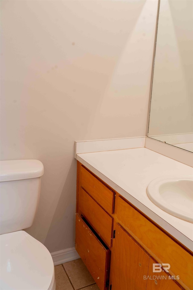 bathroom with vanity, toilet, and tile patterned floors