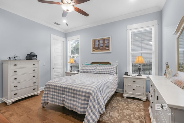 bedroom with ceiling fan, hardwood / wood-style floors, and ornamental molding