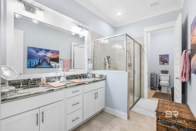 bathroom with tile patterned floors, vanity, toilet, and walk in shower