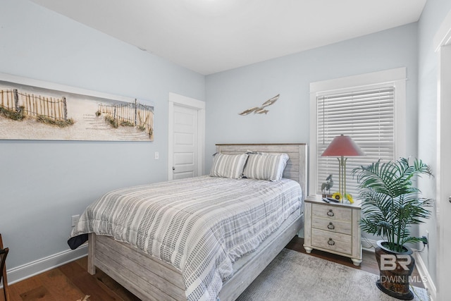 bedroom with dark hardwood / wood-style flooring