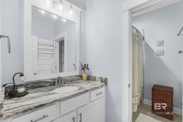 bathroom featuring shower / tub combo with curtain, vanity, and tile patterned flooring