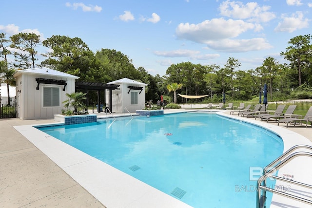 view of pool with a patio area and an outdoor structure