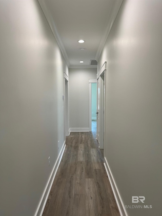 hallway featuring ornamental molding and wood-type flooring