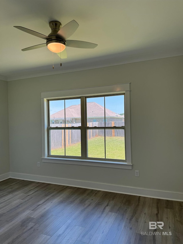 empty room with dark hardwood / wood-style floors and ceiling fan