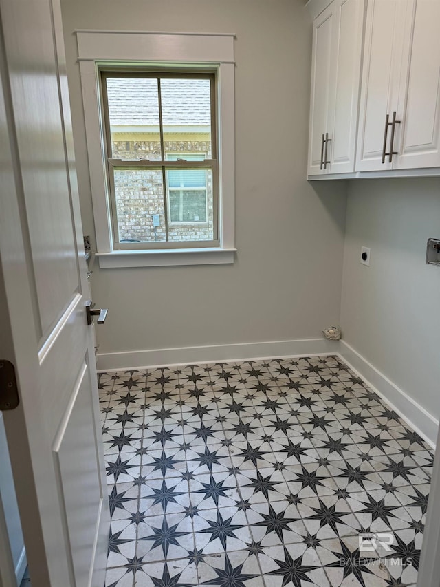 washroom featuring cabinets, light tile floors, and hookup for an electric dryer