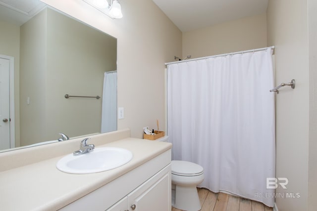 bathroom featuring a shower with curtain, vanity, toilet, and wood finished floors