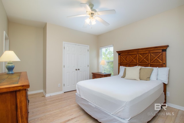 bedroom with baseboards, a closet, a ceiling fan, and light wood-style floors