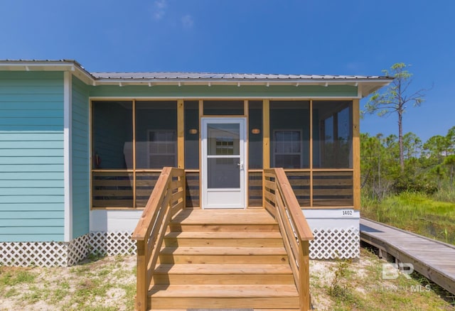 property entrance featuring metal roof