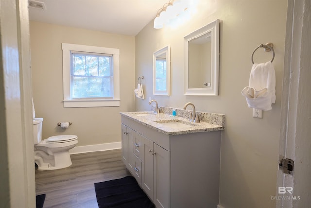 bathroom featuring hardwood / wood-style flooring, vanity, and toilet