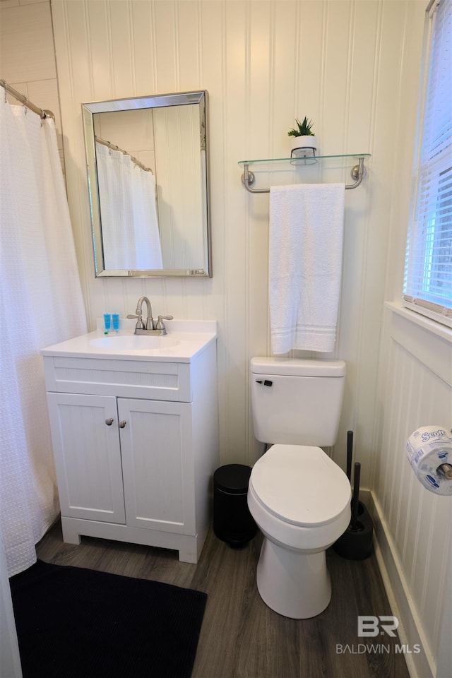 bathroom featuring hardwood / wood-style flooring, vanity, toilet, and a shower with shower curtain