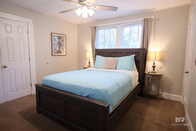 bedroom with dark colored carpet and ceiling fan