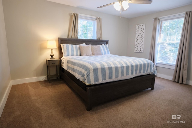 bedroom featuring carpet, multiple windows, and ceiling fan