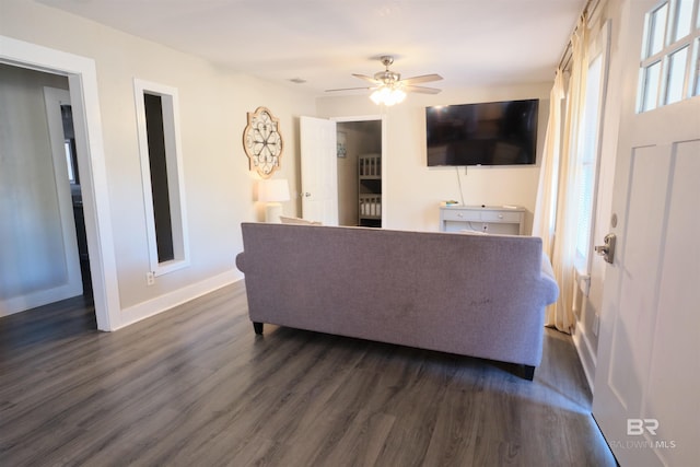 living room with ceiling fan and dark hardwood / wood-style floors