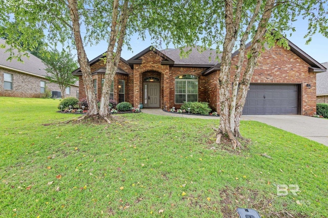 2554 Masters Ct, Mobile, AL 36618 - traditional-style house with brick siding, an attached garage, driveway, a front lawn, and roof with shingles