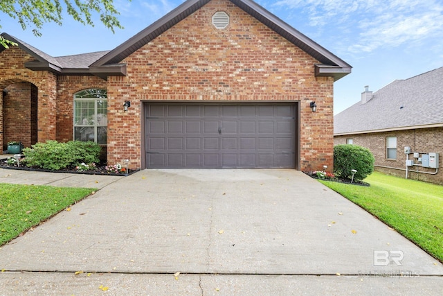 2554 Masters Ct, Mobile, AL 36618 - traditional-style home with brick siding, a front yard, driveway, and an attached garage