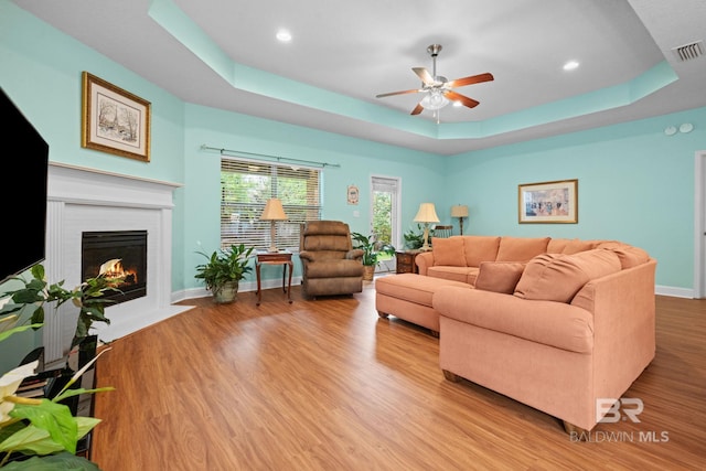 2554 Masters Ct, Mobile, AL 36618 - living room with ceiling fan, a raised ceiling, wood finished floors, a fireplace, and recessed lighting