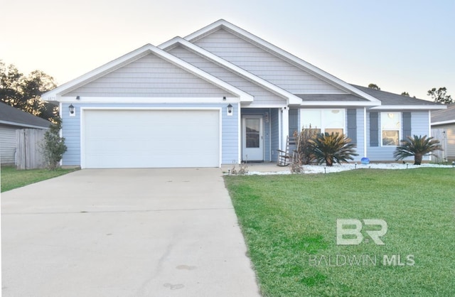 view of front of property with a garage and a yard