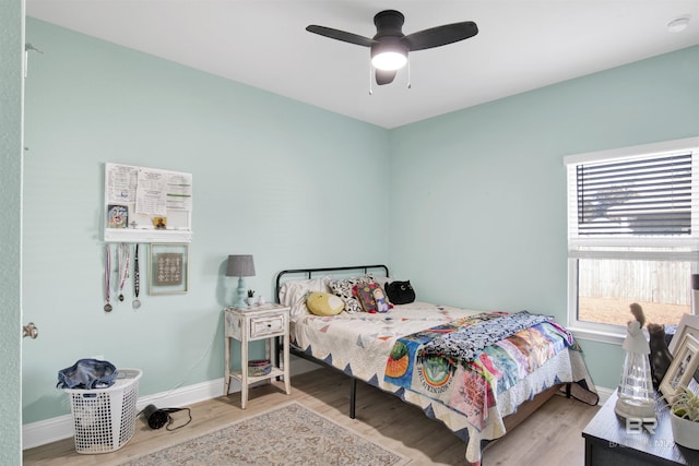 bedroom with ceiling fan and light wood-type flooring