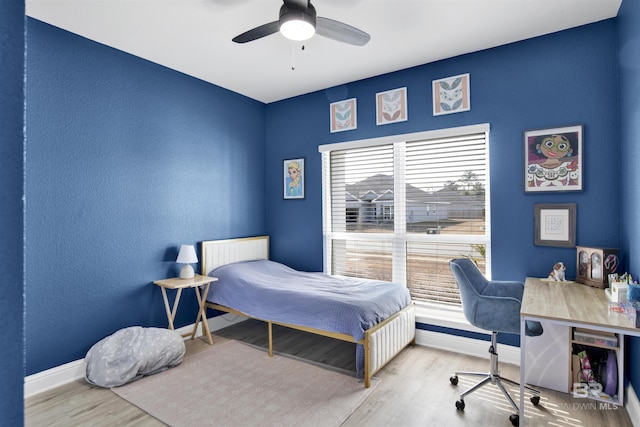 bedroom with ceiling fan and light hardwood / wood-style floors