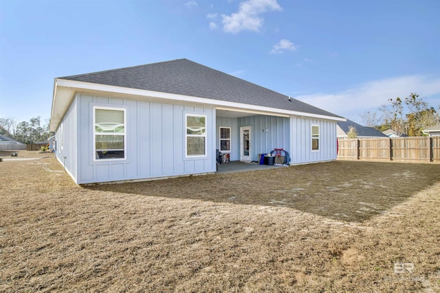 rear view of house featuring a yard