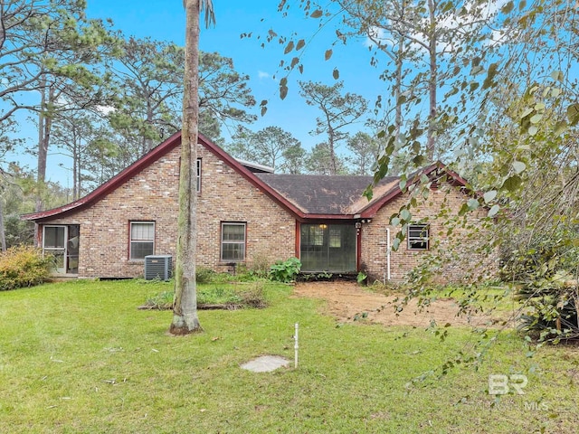 exterior space with cooling unit and a yard