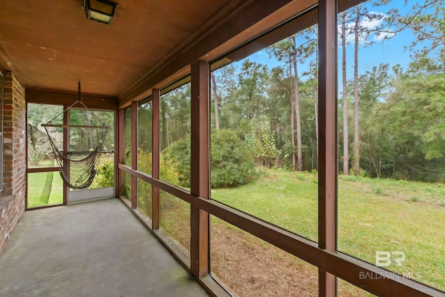 unfurnished sunroom with a wealth of natural light and wooden ceiling