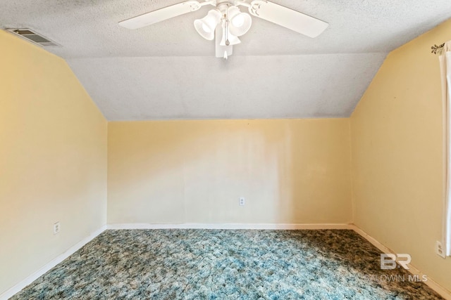 bonus room with carpet flooring, ceiling fan, lofted ceiling, and a textured ceiling