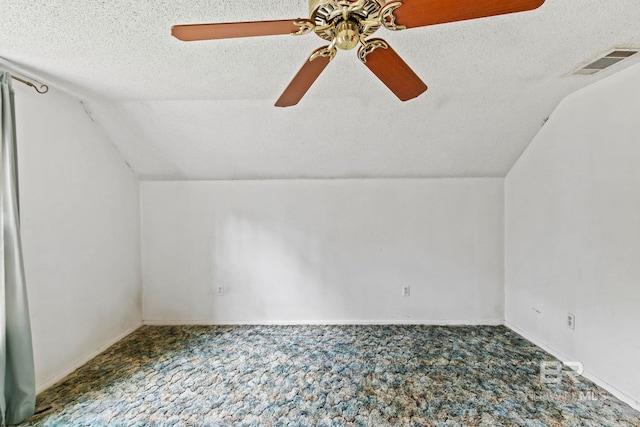 bonus room featuring a textured ceiling, carpet floors, ceiling fan, and lofted ceiling