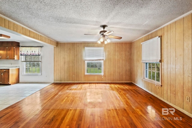 unfurnished living room featuring a healthy amount of sunlight and light hardwood / wood-style flooring