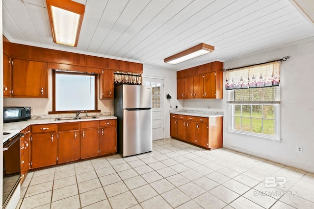 kitchen featuring light tile patterned floors, sink, crown molding, and black appliances