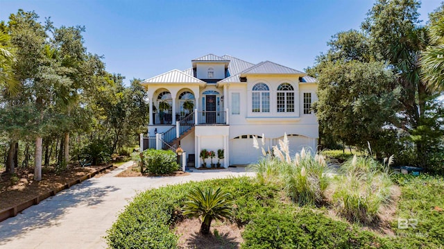 mediterranean / spanish house with a garage and a porch