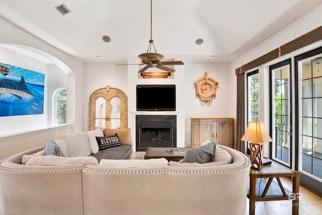 living room featuring lofted ceiling and ceiling fan