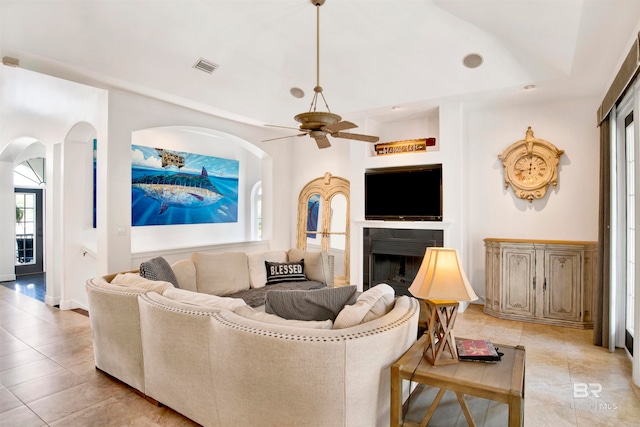 living room featuring light tile patterned floors and ceiling fan