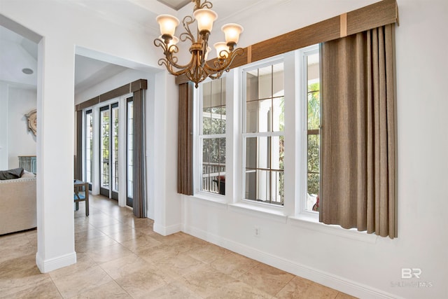 interior space featuring light tile patterned flooring and a chandelier